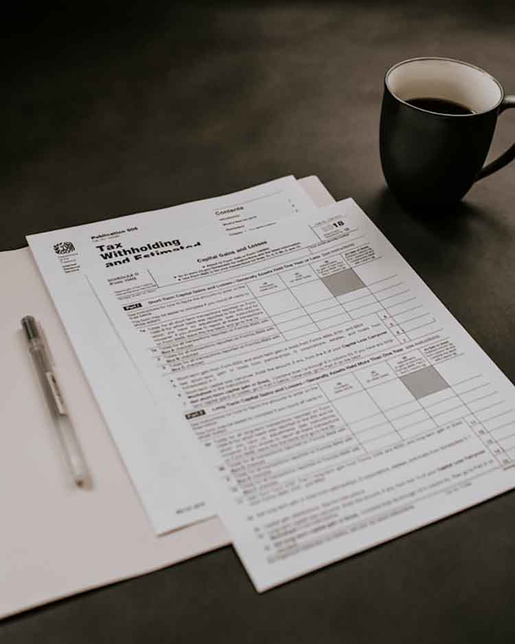 An income tax form and a cup of coffee on a desk